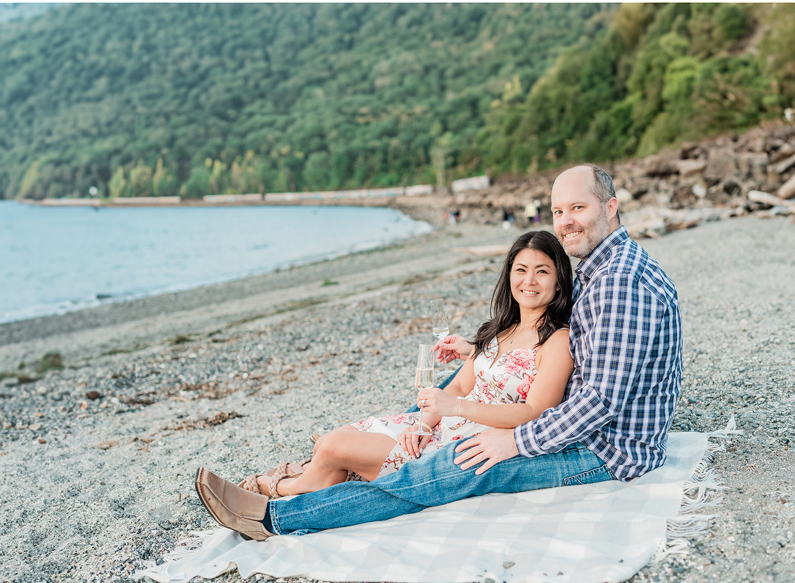 Carkeek Park Engagement Photographer. Couple drinking champagne at the beach