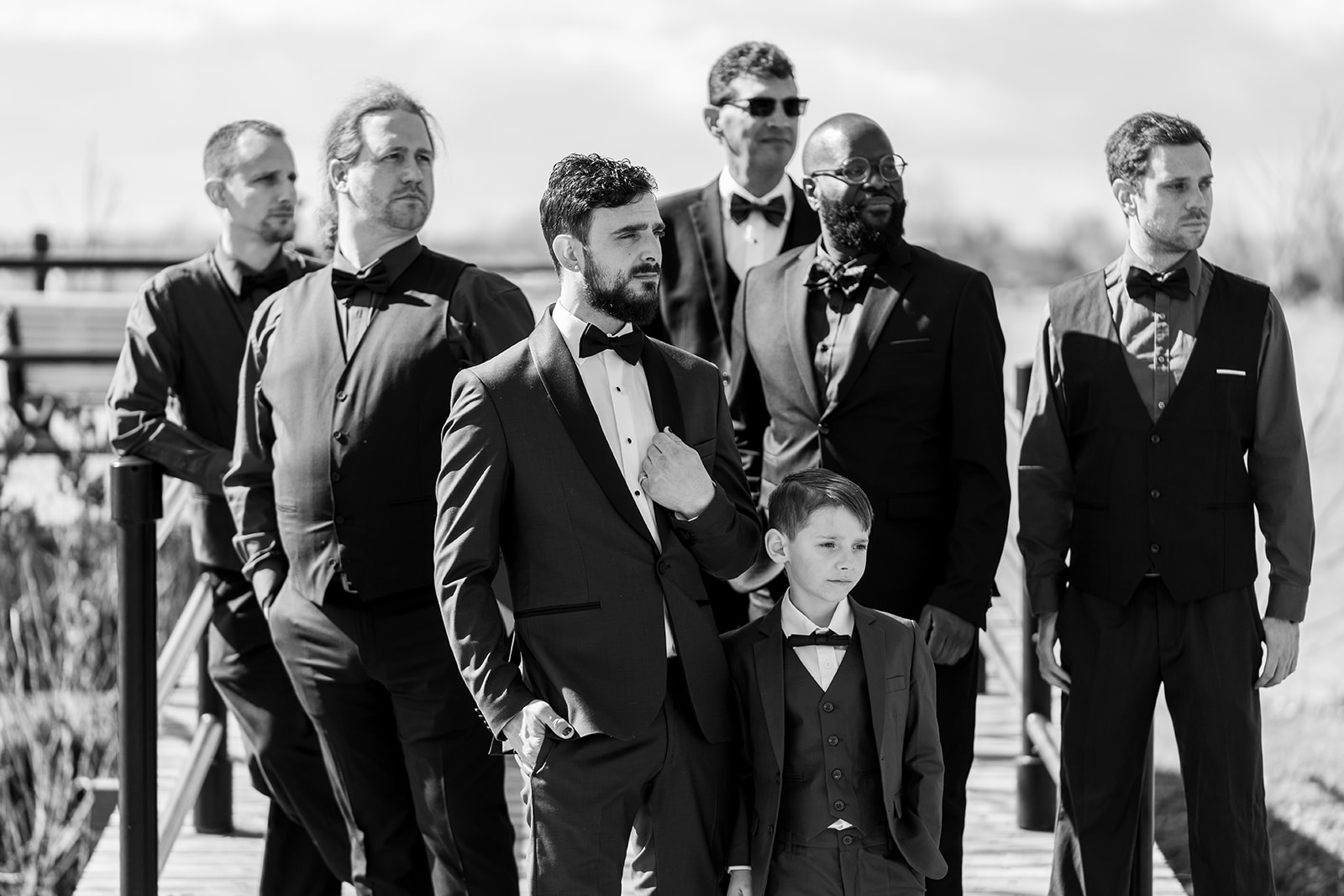 a black and white photograph of groomsmen looking dapper