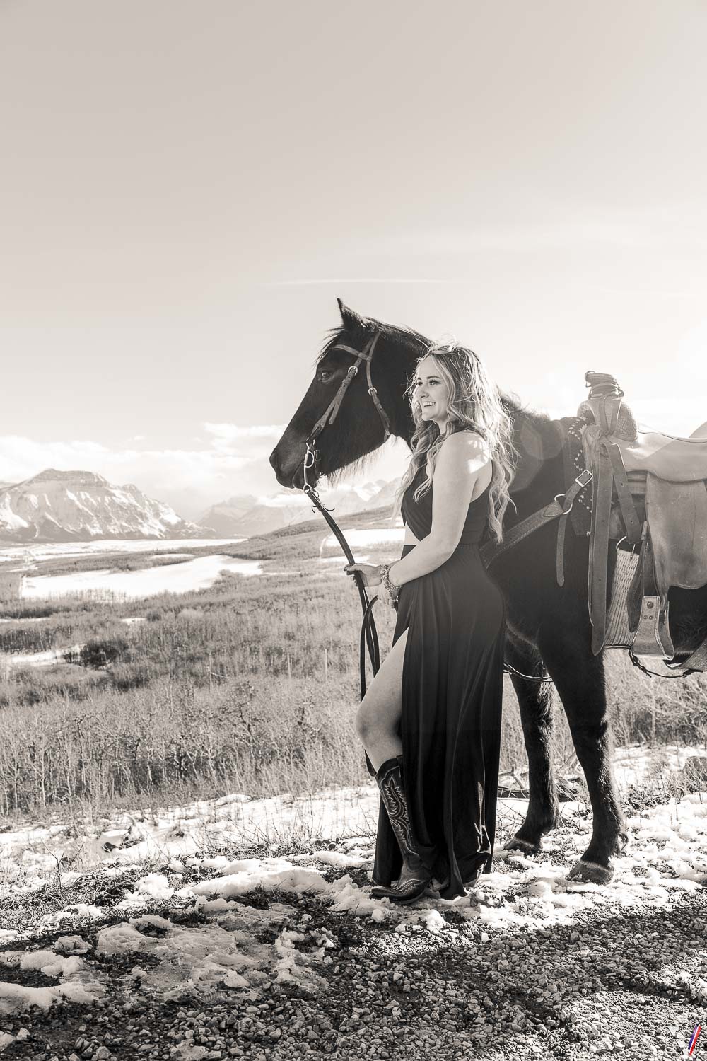 Black long slit dress, cowboy boots and the horse. 