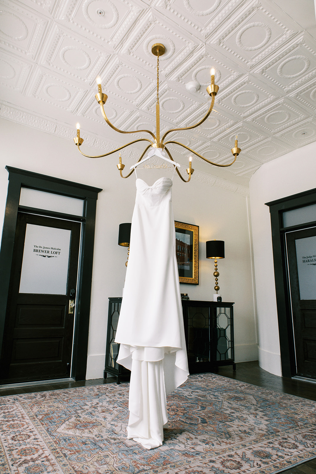 Bride's dress hangs from chandelier at the Lofts on Gault in Fort Payne, Alabama